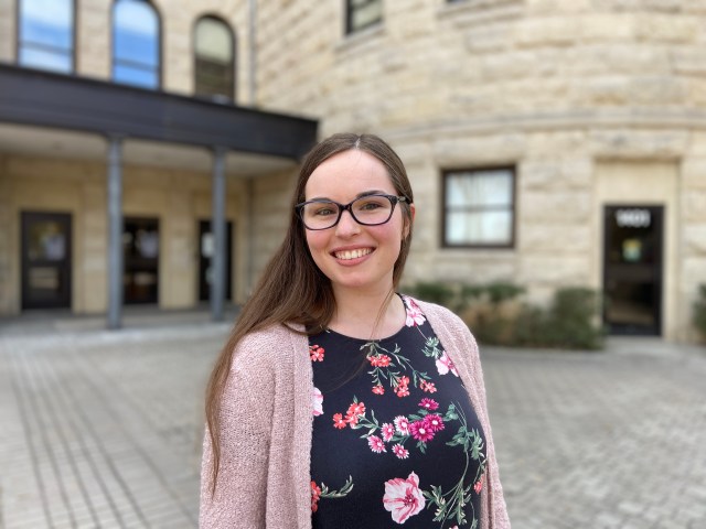Picture of Madelynn Orion in front of the Baylor University English Building