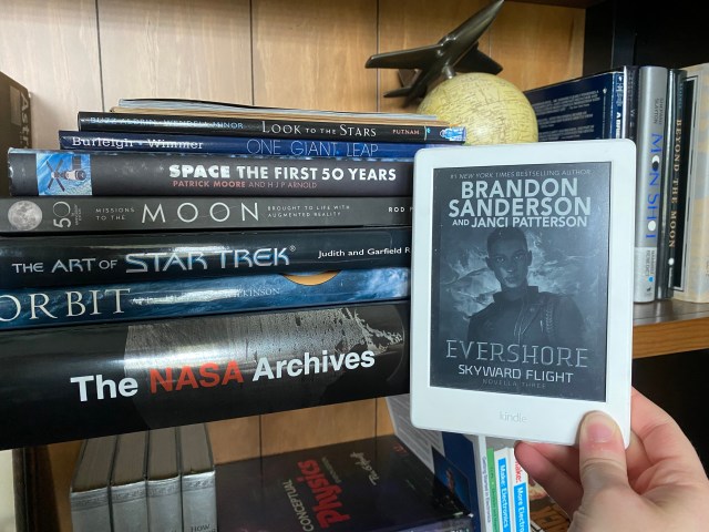 Everhore on Kindle In Front of a space-themed bookshelf
