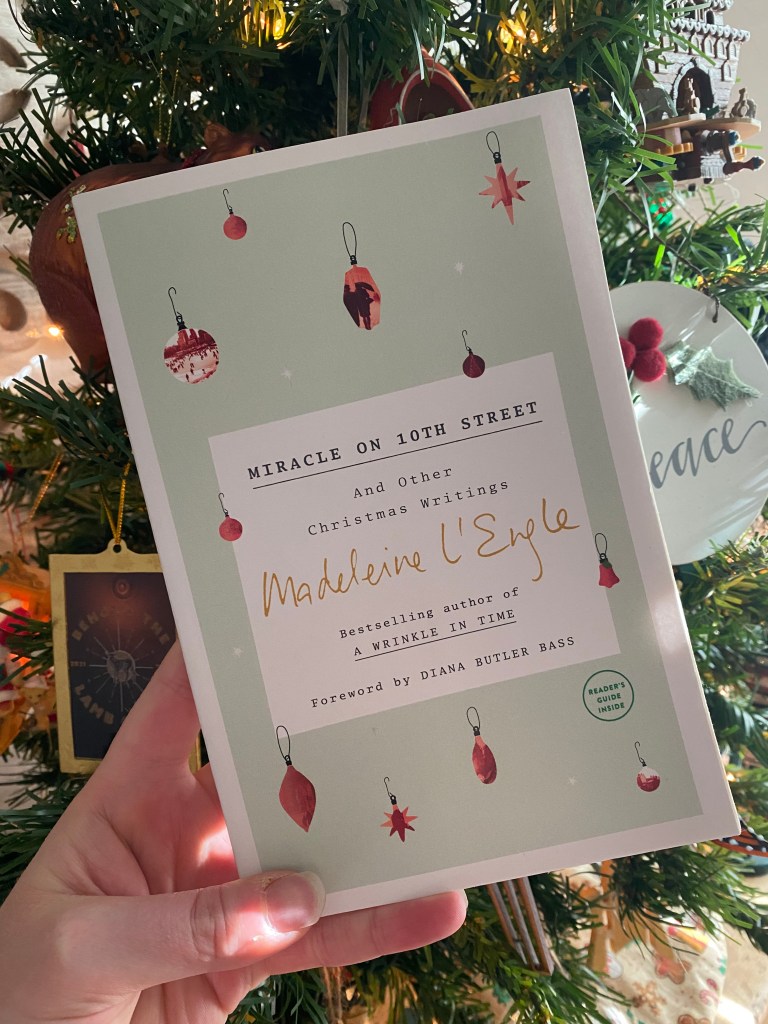Madeline L'Engle's Miracle on 10th Street in front of a Christmas tree